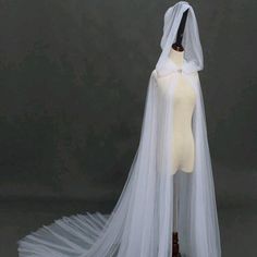 a mannequin wearing a white wedding dress with a veil on it's head