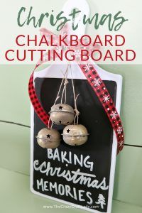 christmas chalkboard cutting board with bells hanging from it and text overlay that reads, christmas chalkboard cutting board