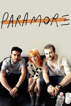 two men and a woman sitting on a couch with the word paramore written above them