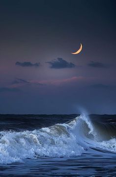 the moon is setting over the ocean waves