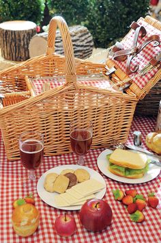 a picnic table with bread, fruit and wine