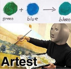 a man is painting with blue and green colors