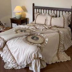 a bed with ruffled bedspread and pillows