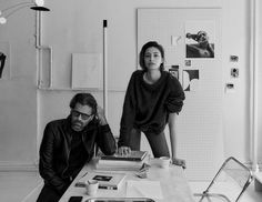 black and white photograph of two people sitting at a table