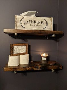 two shelves with toilet paper and candles on them