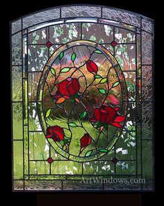a stained glass window with red roses on it