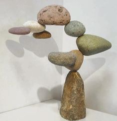 several rocks stacked on top of each other in the shape of a tower with different colors