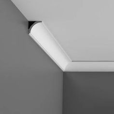 a black and white photo of a ceiling with a light fixture in the corner,