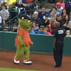 a mascot is standing on the baseball field