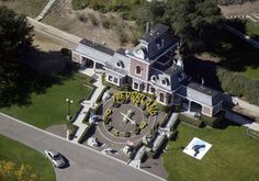 an aerial view of a large house in the middle of a park