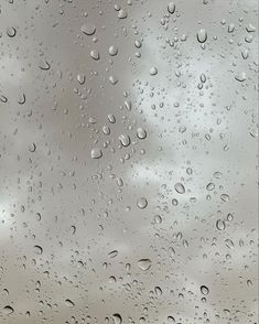 raindrops on the window with clouds in the background