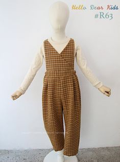 a white mannequin with brown plaid overalls