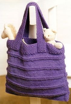 the bag is purple and has two stuffed animals in it, as well as an email address