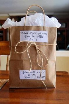 a brown paper bag sitting on top of a wooden table