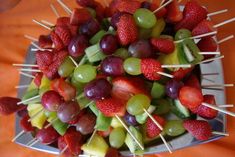 grapes and strawberries are arranged on skewers