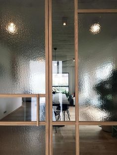 an open glass door leading to a dining room