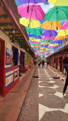 people walking under colorful umbrellas on the street