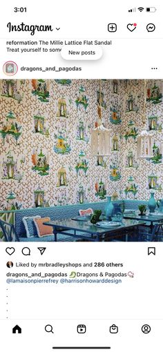 an instagramted photo of a dining room with colorful wallpaper on the walls