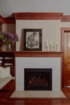 a living room with a fire place and pictures on the wall