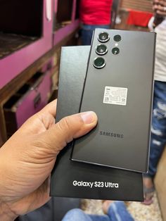 someone is holding up the new samsung galaxy s23 ultra