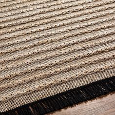 a close up view of a rug with black fringes on the bottom and sides