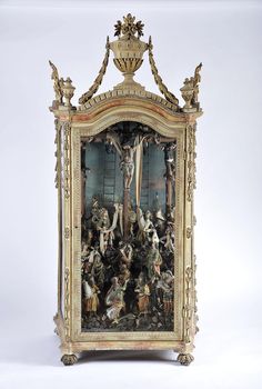 an ornate wooden clock with paintings on it