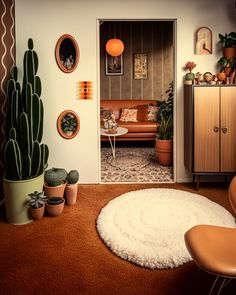 a living room filled with lots of furniture and cactus plants on the wall next to it