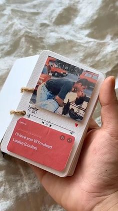 a hand holding a small card with a photo on it