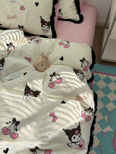 a bed covered in pink and black sheets