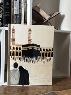 a painting of people in front of the ka'bah on a book shelf