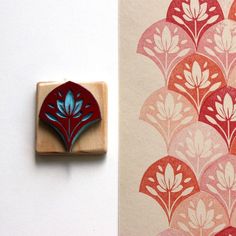 a rubber stamp with a red and blue design on it next to a wallpaper