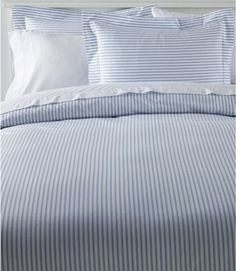 a bed with blue and white striped sheets