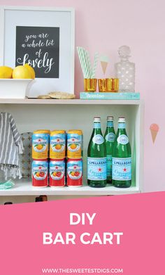 bottles and glasses are sitting on a shelf in front of a wall with pink walls