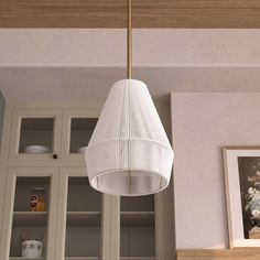 a white light hanging from the ceiling in a kitchen