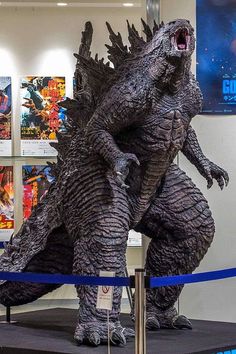 a godzilla statue is on display in a museum