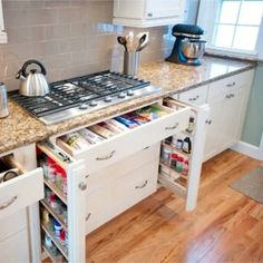 an open drawer in the middle of a kitchen counter