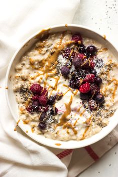 a bowl of oatmeal topped with berries and nuts