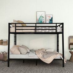 a bunk bed with pillows and blankets on it