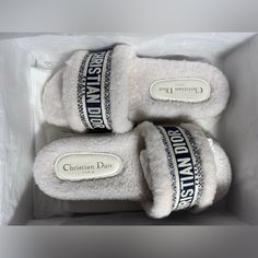 three white slippers in a box with the words christian dube printed on them