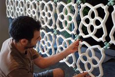 a man is working on an intricately designed wall