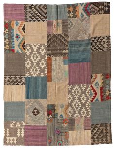 an old patchwork rug with many different colors and patterns on the front, including multi - colored squares