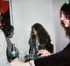 a group of people sitting at a table with wine glasses in front of each other