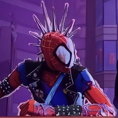 a spider - man with spikes on his head is sitting at a desk