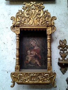 an ornate gold frame with a painting on it