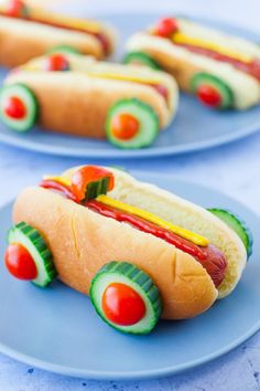 hotdogs with ketchup, mustard and avocado on blue plates