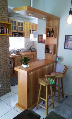 a kitchen with wooden cabinets and two stools