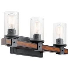 three light bathroom fixture with glass shades on the top and wood trim around the bottom