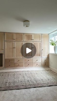 an empty room with wooden cabinets and carpet