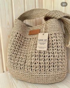 a crocheted purse with a tag on it