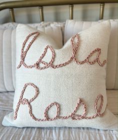 a white pillow with the word ella rose written on it
